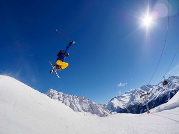 Low angle view of person jumping on ski slope