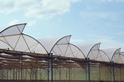 Low angle view of greenhouse against sky