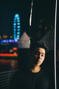 Close-up portrait of young man at night