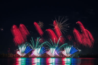 Low angle view of firework display at night