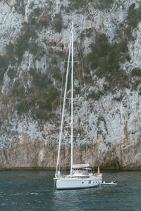 Boat sailing on sea against sky