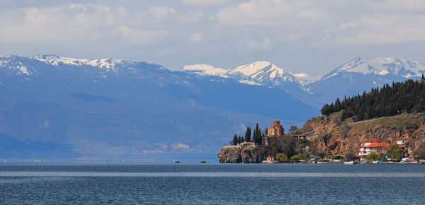 Panoramic view of calm sea against mountain range