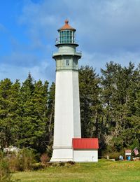 Low angle view of lighthouse against cloudy sky