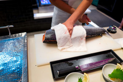 Midsection of woman preparing food