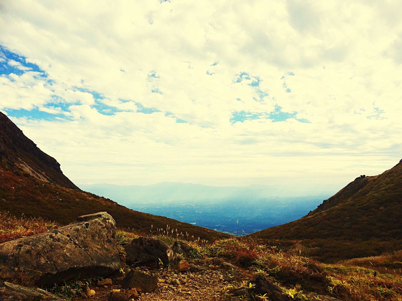 mountain, tranquil scene, tranquility, scenics, sky, landscape, beauty in nature, mountain range, cloud - sky, nature, non-urban scene, cloud, cloudy, physical geography, idyllic, remote, geology, day, outdoors, no people