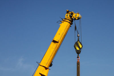 Low angle view of cross against clear blue sky