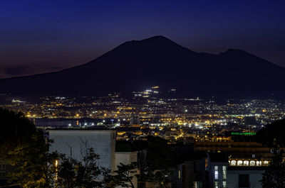High angle view of illuminated buildings in city at night
