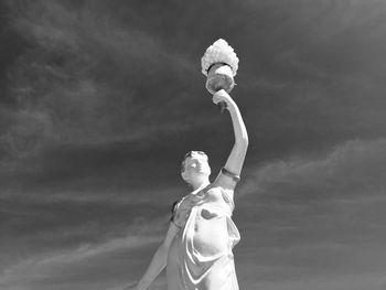 Low angle view of statue against sky