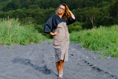 Portrait of mid adult woman standing on sand