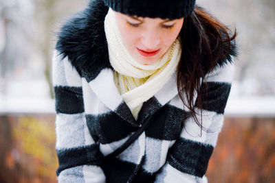 Midsection of woman wearing winter coat while looking down
