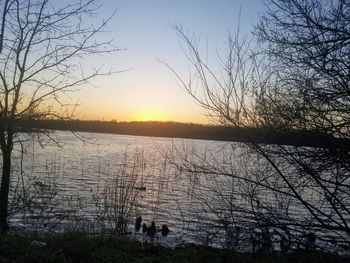 Scenic view of lake against sky during sunset