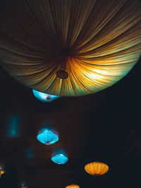 Low angle view of illuminated lantern hanging against sky