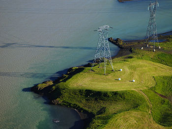 Aerial image of high voltage poles at a glacier river in iceland