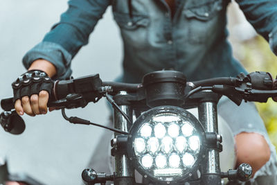 Close-up of illuminated motorcycle headlights