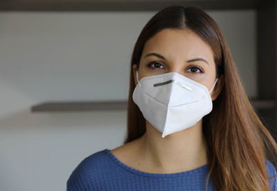 Close-up portrait of beautiful young woman wearing mask