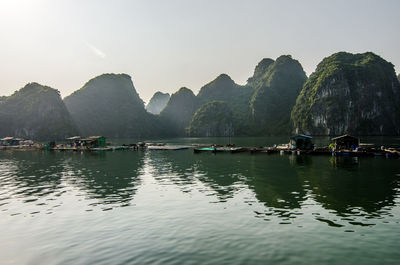 Scenic view of river and mountains against clear sky