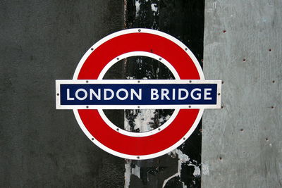 Close-up of london bridge underground sign on wall