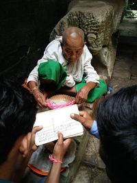 High angle view of people reading book