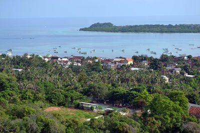 High angle view of sea and buildings against sky