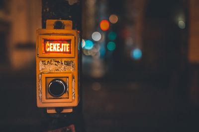 Close-up of information sign on road at night