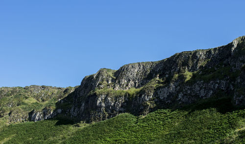 Scenic view of mountains against clear blue sky