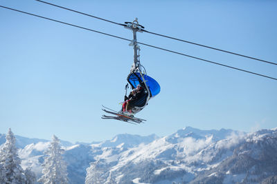 Skiers sitting on a ski lift. ski resort alpendorf in the austrian alps