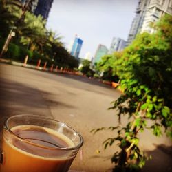 Close-up of drink on table in city