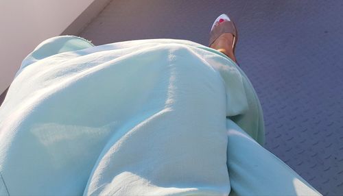 Low section of woman relaxing on floor