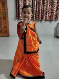 Full length of girl wearing sari standing at home