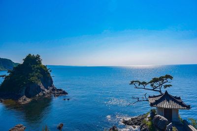 Scenic view of sea against clear blue sky