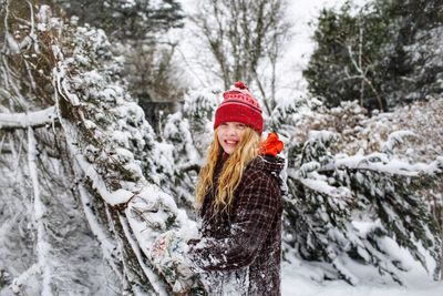 Portrait of smiling woman in snow