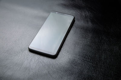 High angle view of smart phone on table