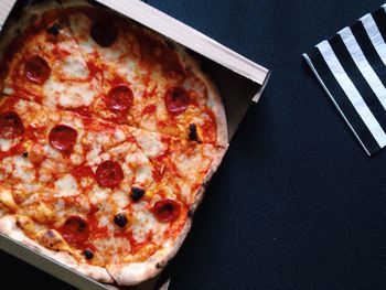 Directly above view of fresh margharita pizza in box on table