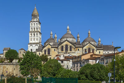 Low angle view of buildings against blue sky