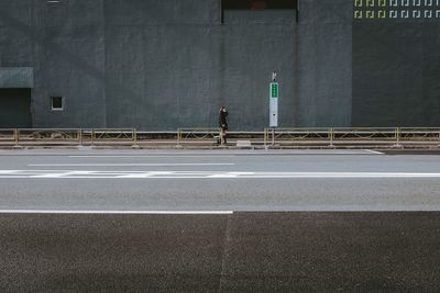 Side view of a man walking on road