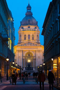 Group of people in front of building at dusk