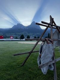 Rear view of man standing on field against sky
