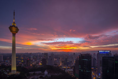 Communications tower against sky during sunset