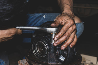 Cropped hand of man repairing car