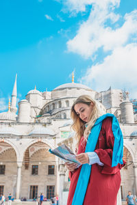 Woman standing in front of building