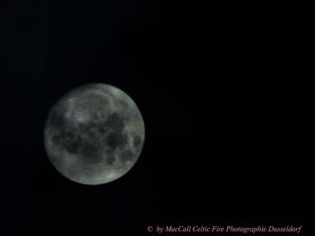 Low angle view of moon against clear sky at night