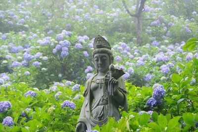 Statue of flower against plants