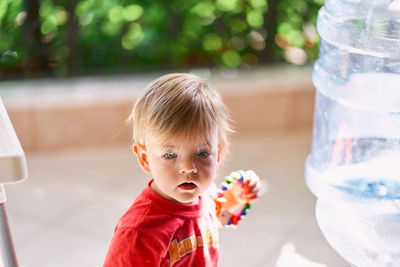 Portrait of cute boy looking through glass