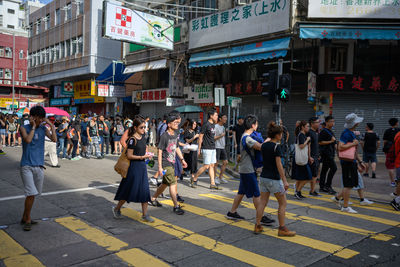 Group of people walking on city street