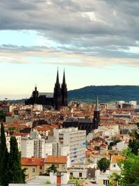 High angle shot of townscape against cloudy sky