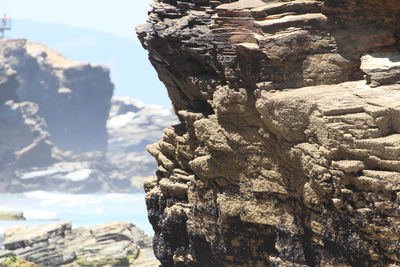 Close-up of rock formation in sea against sky