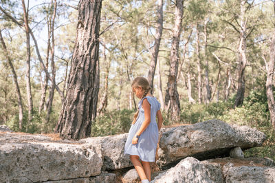Kid girl traveler of eight years old explore ancient excavations of ruins ancient lycian city