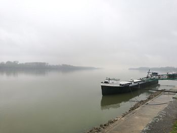 Fishing boat in sea against sky