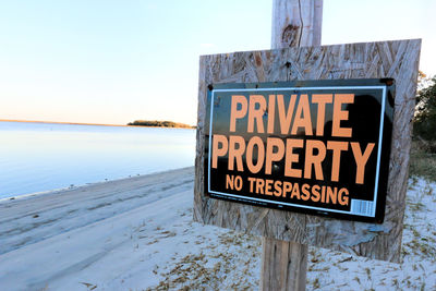 Close-up of signboard against clear sky