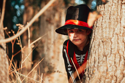 Portrait of boy wearing costume during halloween at forest